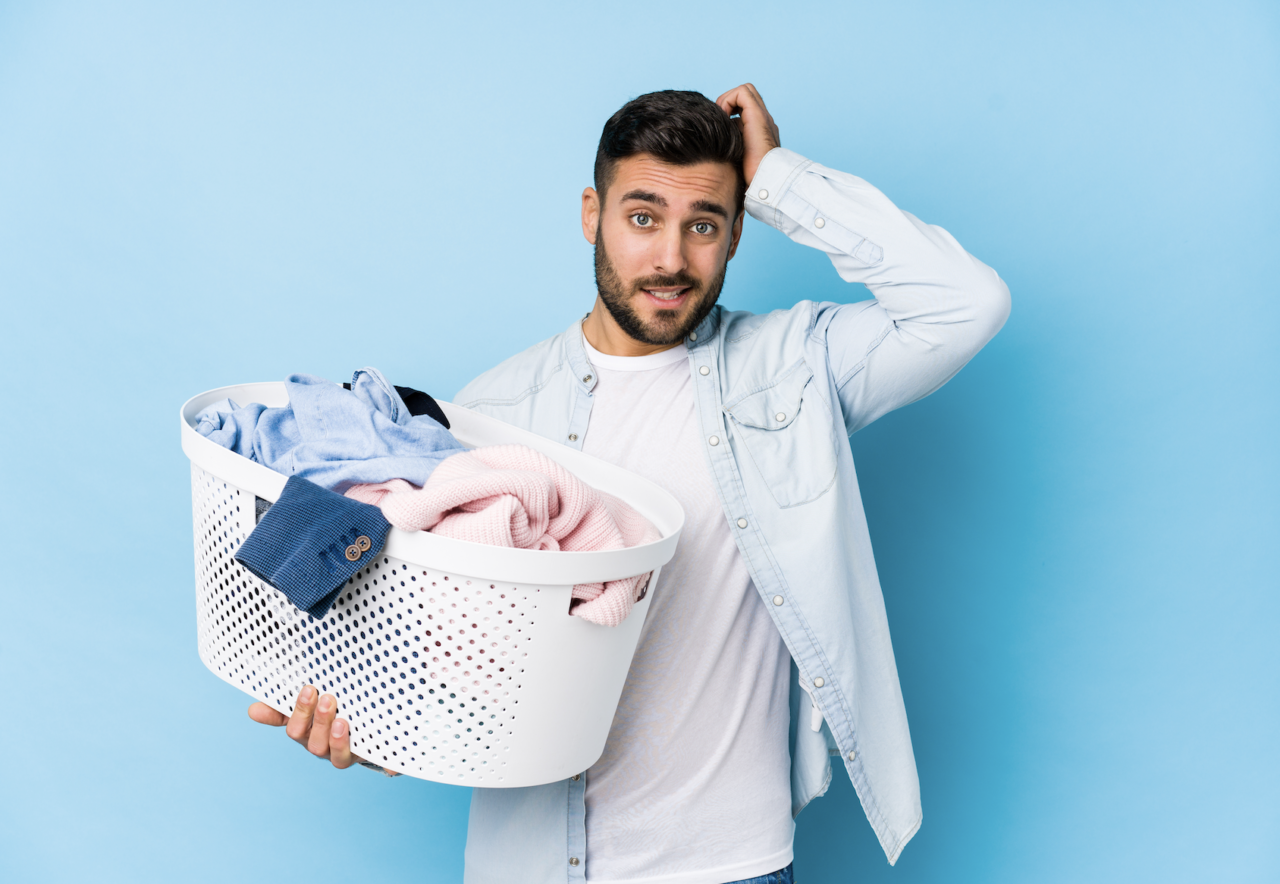 Confused Man holding laundry basket